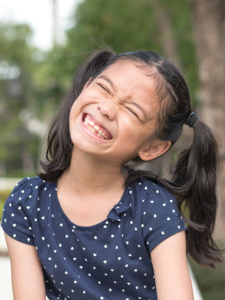 istock Asian girl child showing front teeth with big smile 1033796408