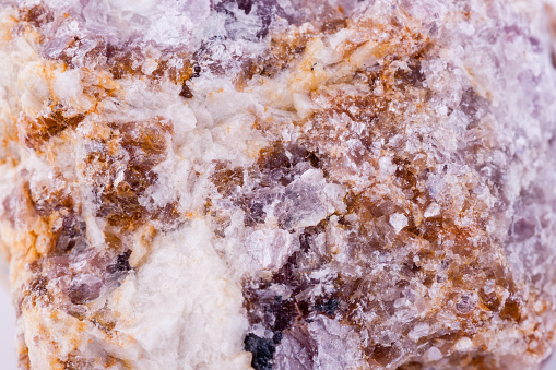 macro mineral stone lepidolite on a white background close up