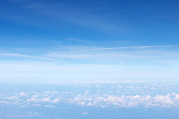 istock white cumulonimbus clouds and blue sky. View from the airplane window. 1033807828