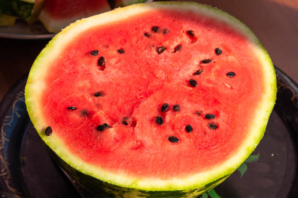 istock Half a cut watermelon on a plate 1033810786