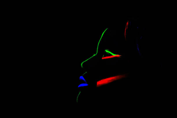 istock A woman in the dark with fluorescent makeup 1033811190