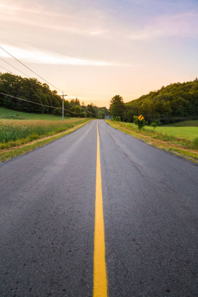 istock Long country highway with yellow lines down the centre. 1033814236
