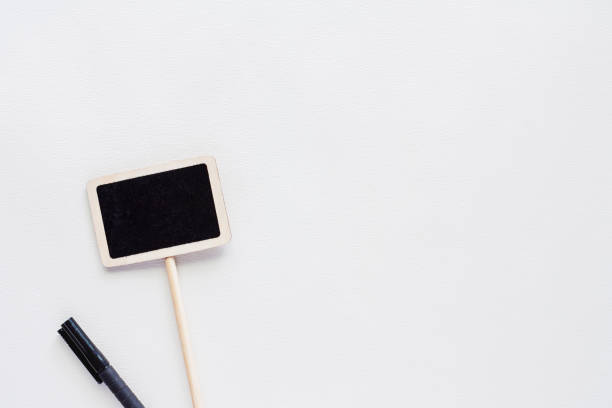Blank blackboard label stick with pen on white background for writing information on it