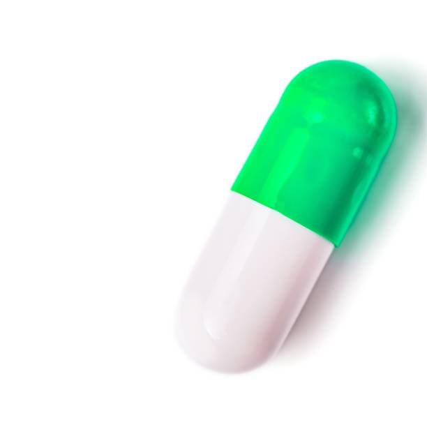 istock Medicine green and yellow pills or capsules 1033819384