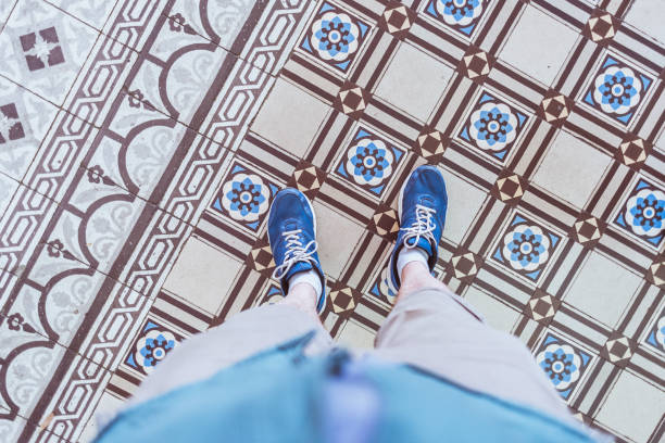 Blue sneakers on the antique tiled floor