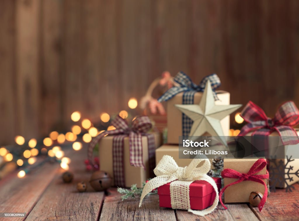 Christmas gifts against a wooden background Christmas Eco Friendly Gift Boxes and Decorations on an Old Wooden Background Christmas Present Stock Photo