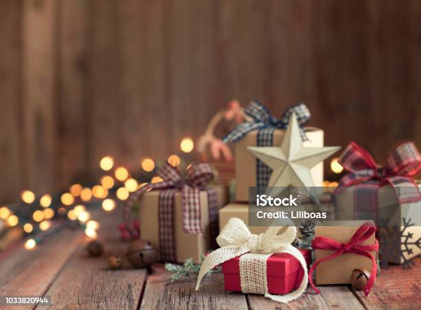 Christmas Gifts Against A Wooden Background Stock Photo - Download Image Now - Christmas Present, Christmas, Gift