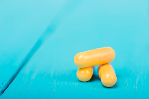 istock Medicine green and yellow pills or capsules 1033830896