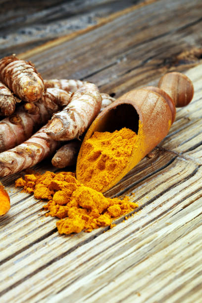 istock Turmeric powder and fresh turmeric on grey background 1033833304