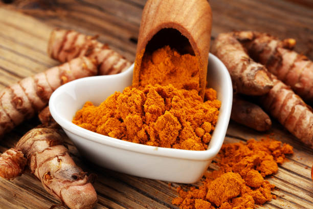 istock Turmeric powder and fresh turmeric on grey background 1033833684