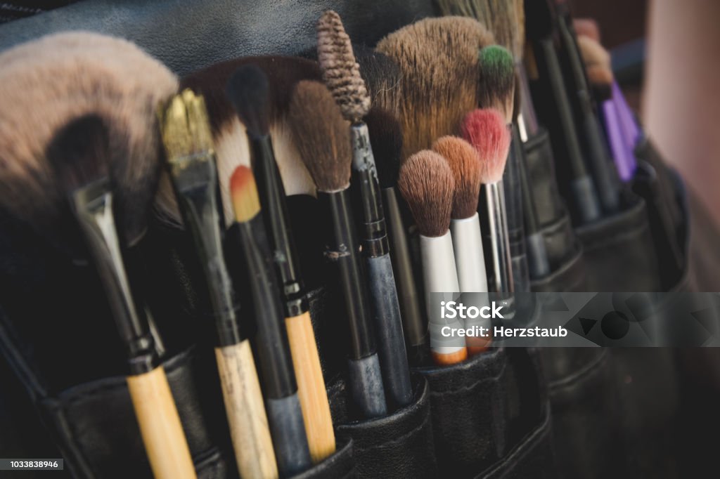 Close up view on black packet of paintbrushes Close up view on large black leather packet of assorted sizes and shapes of paintbrushes. Includes copy space. Beautician Stock Photo