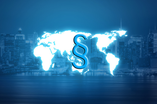 paragraph law symbol over world map hologram and blurred city background