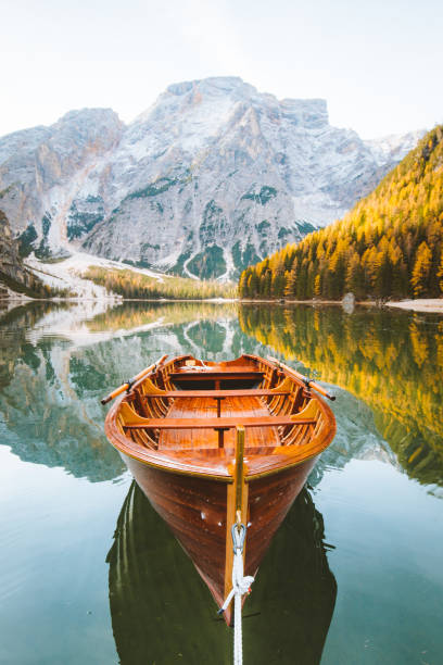 istock Traditional rowing boat on a lake in the Alps in fall 1033839400