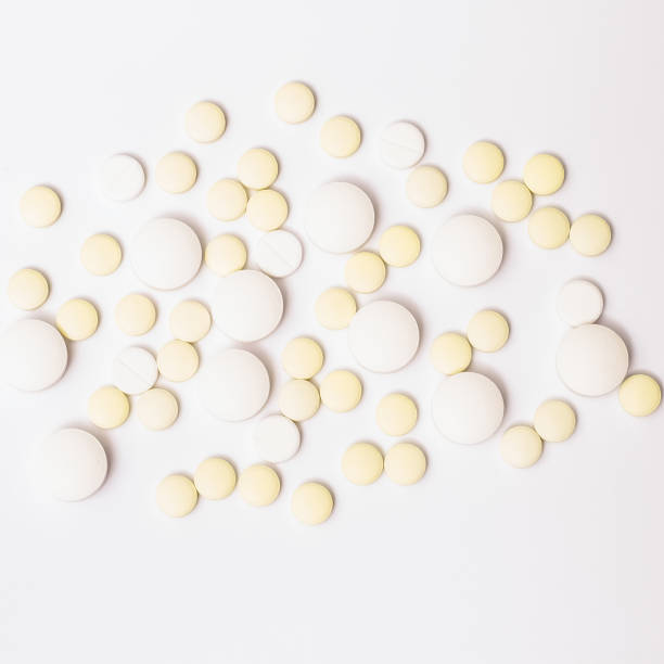 istock Medicine white and yellow pills or capsules 1033842770