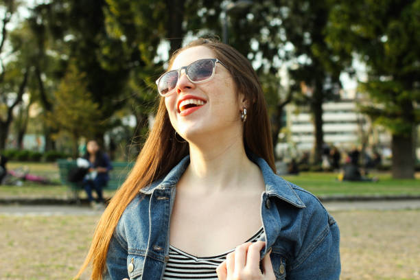 istock Young joyful woman enjoying herself at the park 1033846848