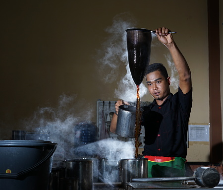Traditional process of Aceh coffee making by Barista at Local Coffee Shop