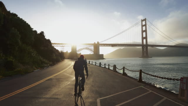 Commuter with road racing bicycle and Golden Gate Bridge