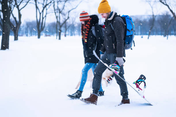 istock Young couple enjoying winter with dogs 1033886030