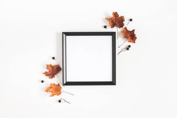 istock Autumn composition. Photo frame, dried leaves on white background. Autumn, fall, halloween concept. Flat lay, top view, copy space, square 1033889964