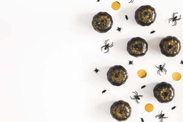 istock Hallowen decorations, black pumpkins on white background. Halloween concept. Flat lay, top view, copy space 1033890060
