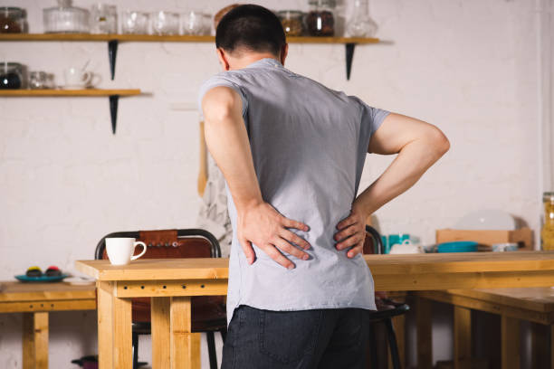 dor de costas, inflamação de rim, homem que sofre de dor nas costas em casa - back rear view low section pain - fotografias e filmes do acervo