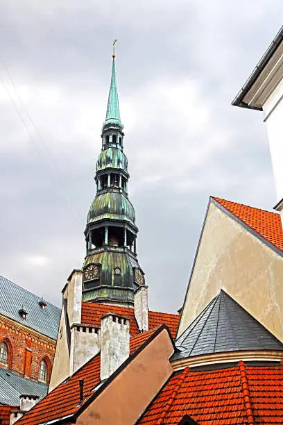 Roofs of buildings in old town and top view of church of St. Peter (St. Peter's Church, Petrikirche) is one of the symbols and one of the main sights of the city, Riga, Latvia