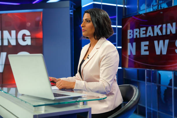 istock Breaking news female anchor from the side 1033921534