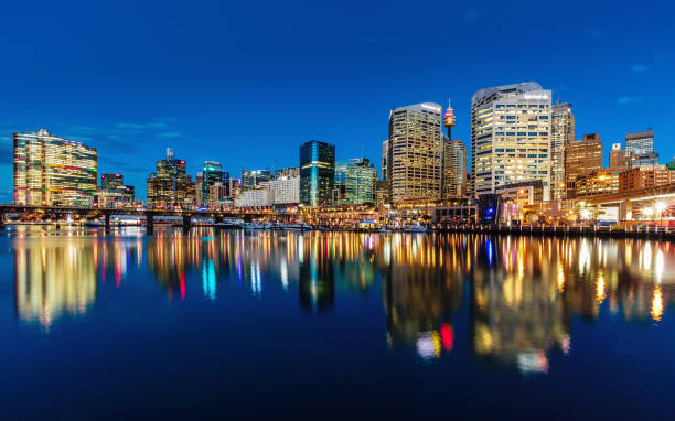Beautiful illuminated modern Skyscraper Cityscape of Darling Harbour reflecting in the harbor. Darling Harbour, Sydney, New South Wales, Australia.