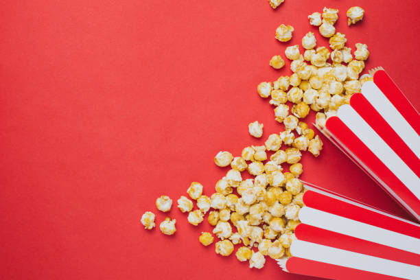 istock Popcorn on a red background top view in cinema 1033938804