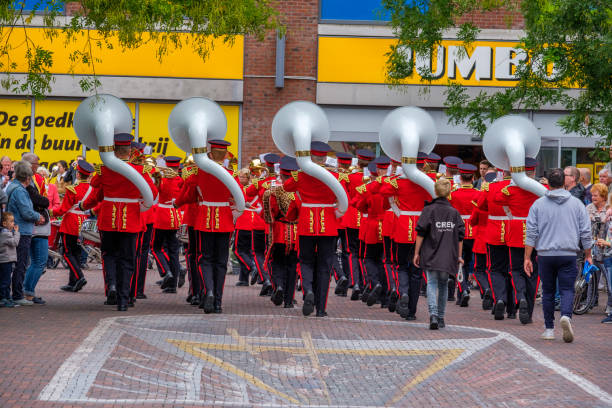 musicisti colorati in belle uniformi marciano per le strade di delft, nei paesi bassi. - marching band trumpet bugle marching foto e immagini stock