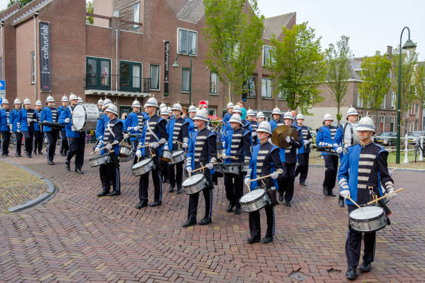 musicisti colorati in belle uniformi marciano per le strade di delft, nei paesi bassi. - marching band trumpet bugle marching foto e immagini stock