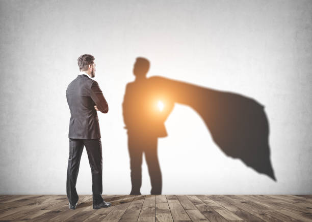 istock Businessman looking at his superman shadow in room 1033949650