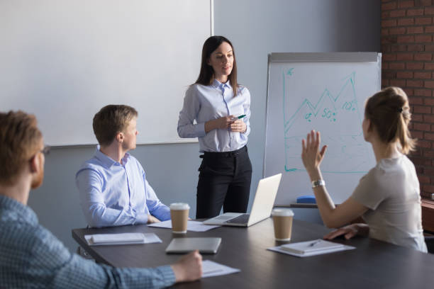 istock Female employee asking question to business speaker during meting 1033950642