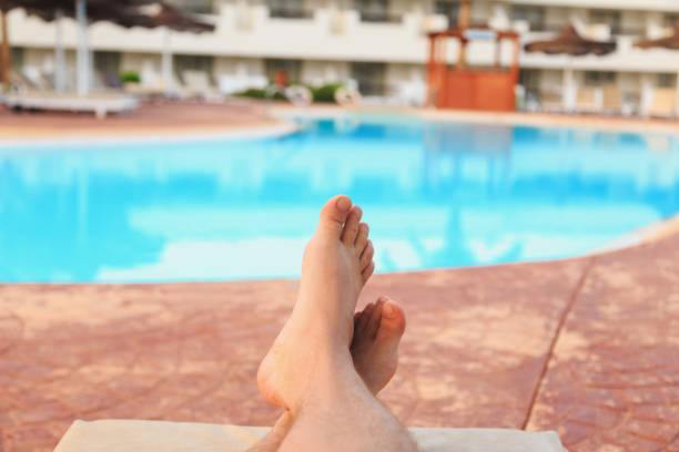 istock man relaxing by the pool 1033953504