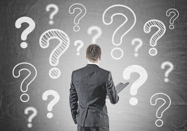 istock Businessman with folder, rear view, many questions 1033954524