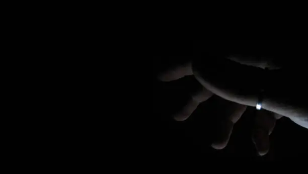 a hand in the dark
