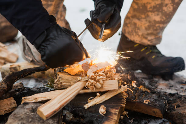 istock Male hand starts fire with magnesium fire steel, fire striker 1033962410