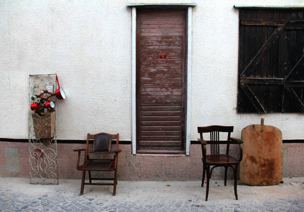 wooden chairs on the street-metal accessories on the wall