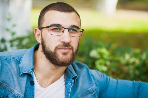 istock Handsome young man in glasses with beard relax outdoors 1033963056