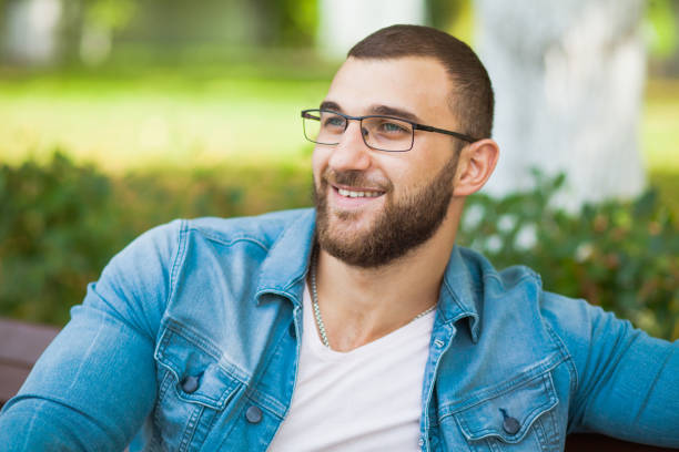 istock Handsome young man in glasses with beard relax outdoors 1033963080