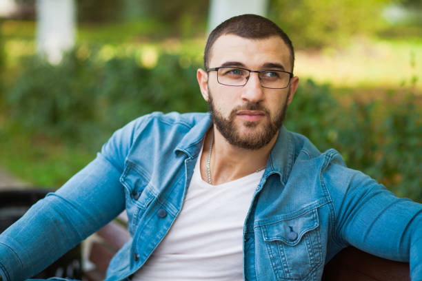 istock Handsome young man in glasses with beard relax outdoors 1033963094