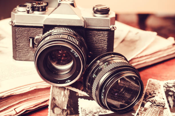 istock Old retro vintage camera and books. Vintage effect 1033965488