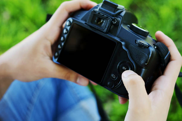 istock Professional woman looking at photo camera 1033970892