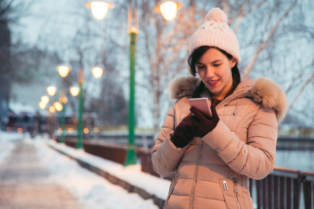 istock Woman using phone in the winter 1033971006