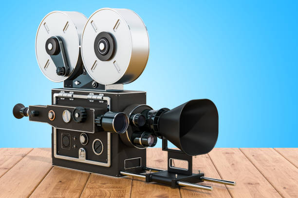 Old movie camera on the wooden table. 3D rendering
