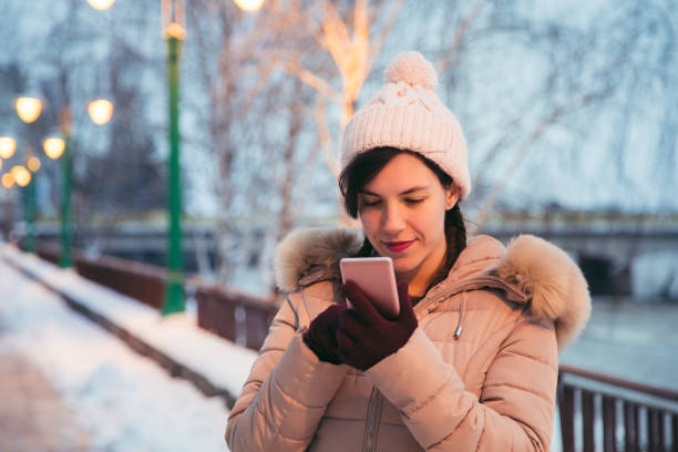 istock Woman using phone in the winter 1033971524