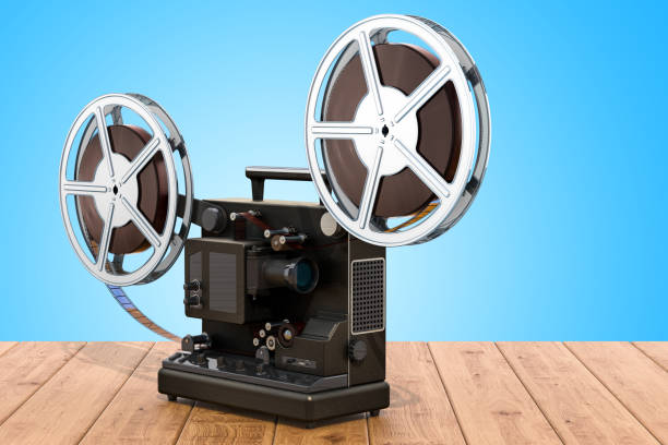 istock Retro cinema projector on the wooden table. 3D rendering 1033971536