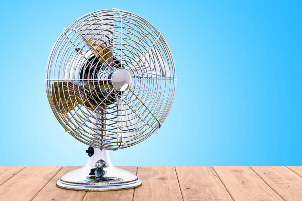 istock Vintage Table Fan on the wooden table, 3D rendering 1033971564