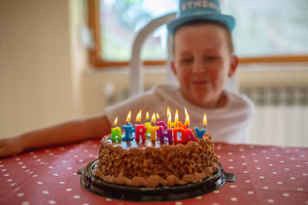 istock Boy with a fun hat celebrating his birthday with his loved ones 1033973986