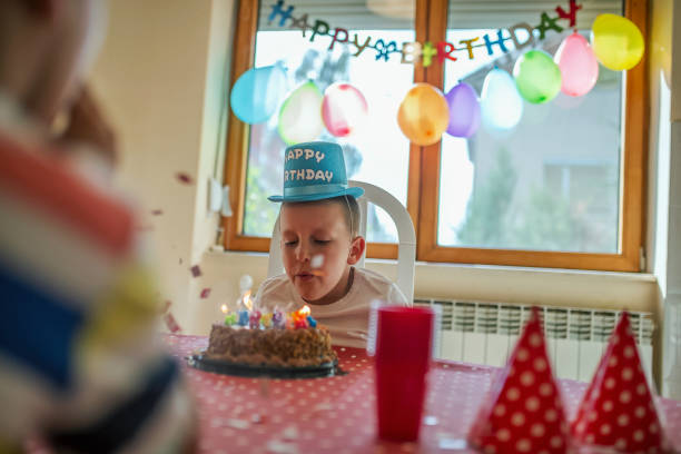 istock Boy with a fun hat celebrating his birthday with his loved ones 1033980954